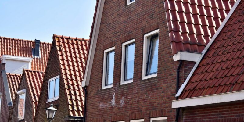 a row of red brick houses with white windows